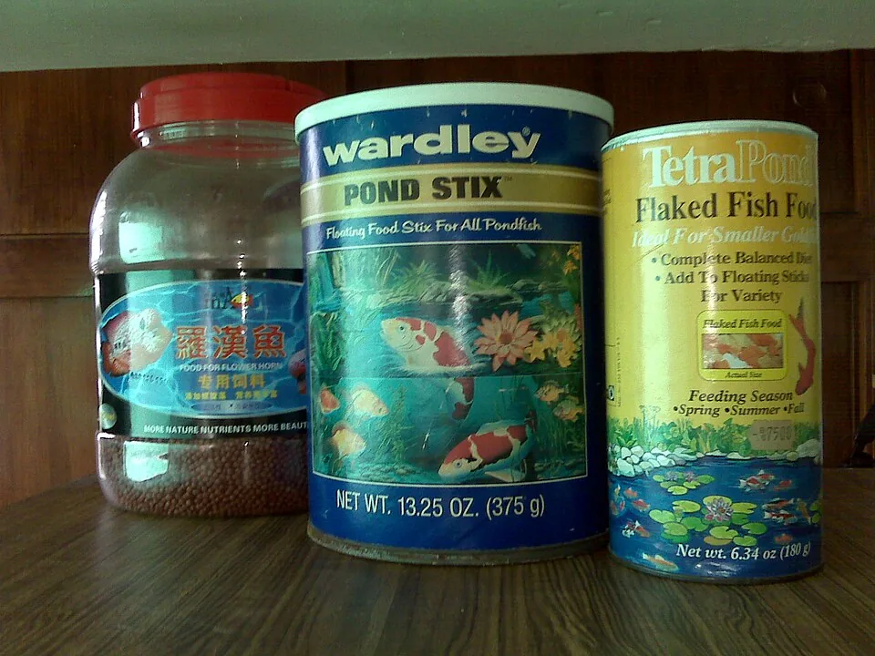 Several fish-food containers with their package labels visible